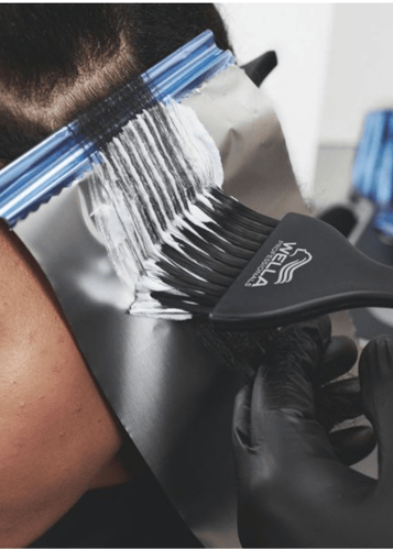 stylist applying foiling techniques to hair