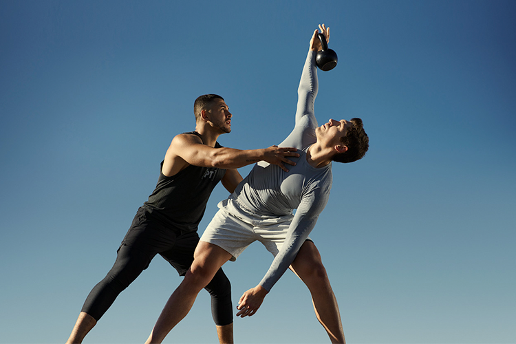 certified personal trainer stretching with client